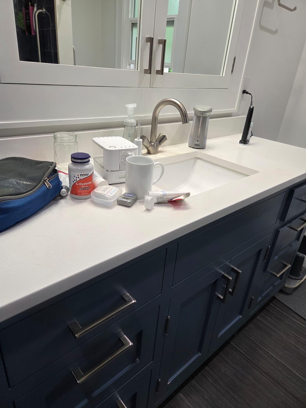 Cluttered bathroom vanity before Serve cleaning